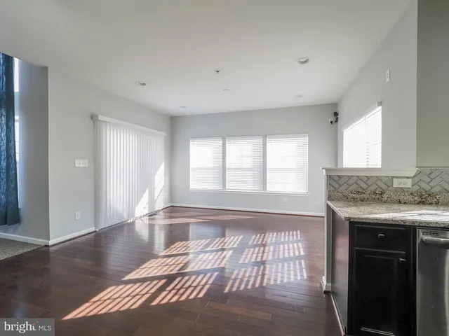 a view of staircase with wooden floor and white walls
