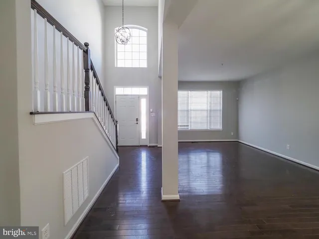 a view of staircase with railing and a window