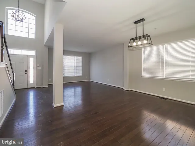 a view of a staircase with wooden floor and windows