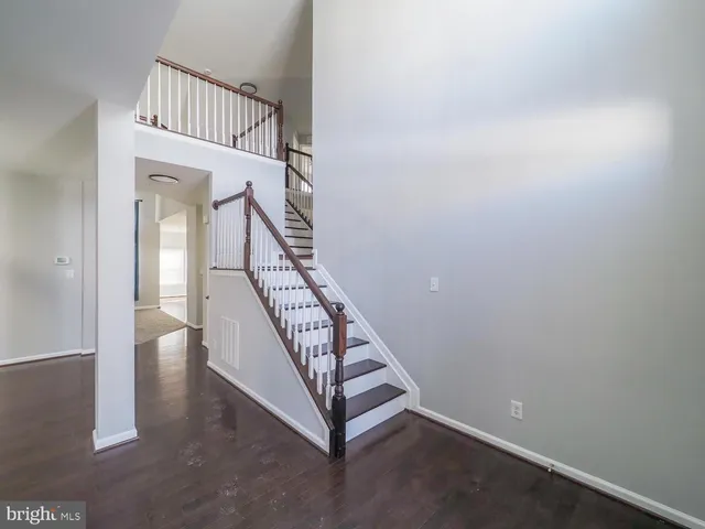 a view of hallway with wooden floor