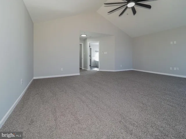 a view of room with a ceiling fan and window