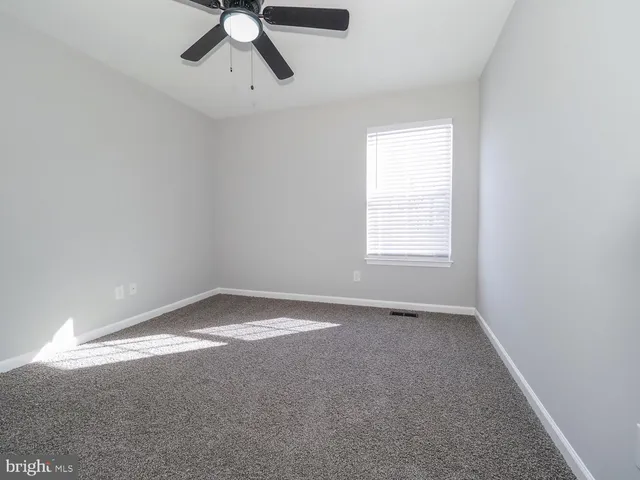 a view of an empty room and wooden floor