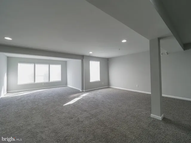 a view of hallway with wooden floor and window