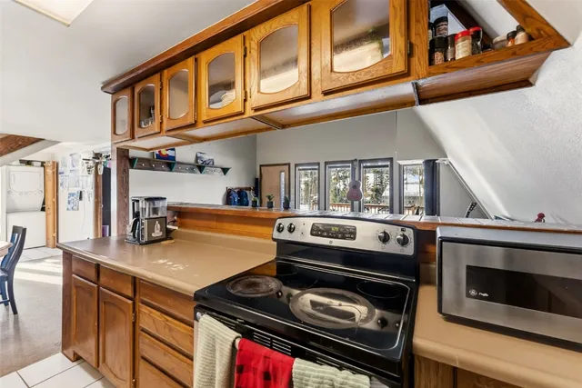 a kitchen with stainless steel appliances granite countertop a stove and a microwave