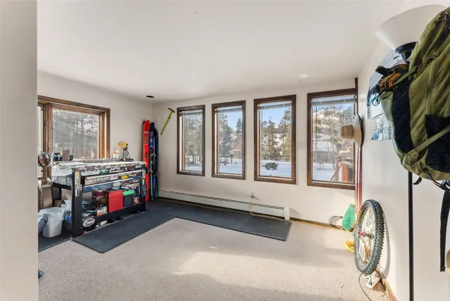 a bedroom with furniture a flat screen tv and a large window