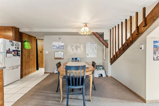 a view of a dining room with furniture and a chandelier