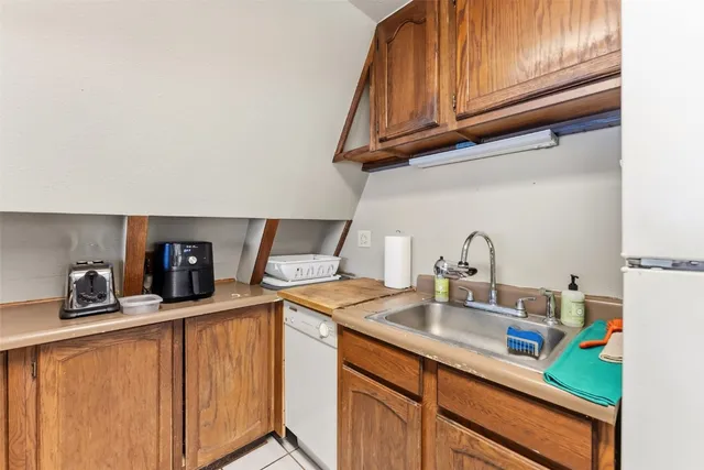 a kitchen with stainless steel appliances granite countertop a sink and cabinets