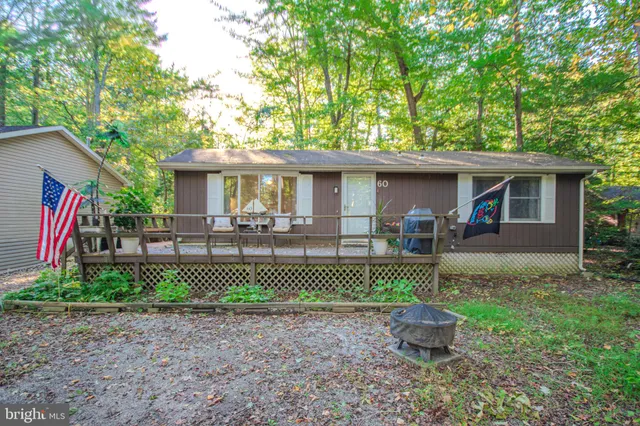 a front view of a house with a yard table and chairs