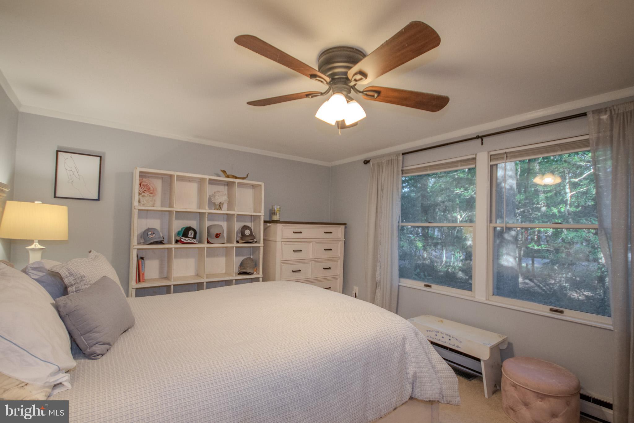 60 Beaconhill Road Ocean Pines, MD 21811 - Photo 16 of 30 a bedroom with a large bed and a large window