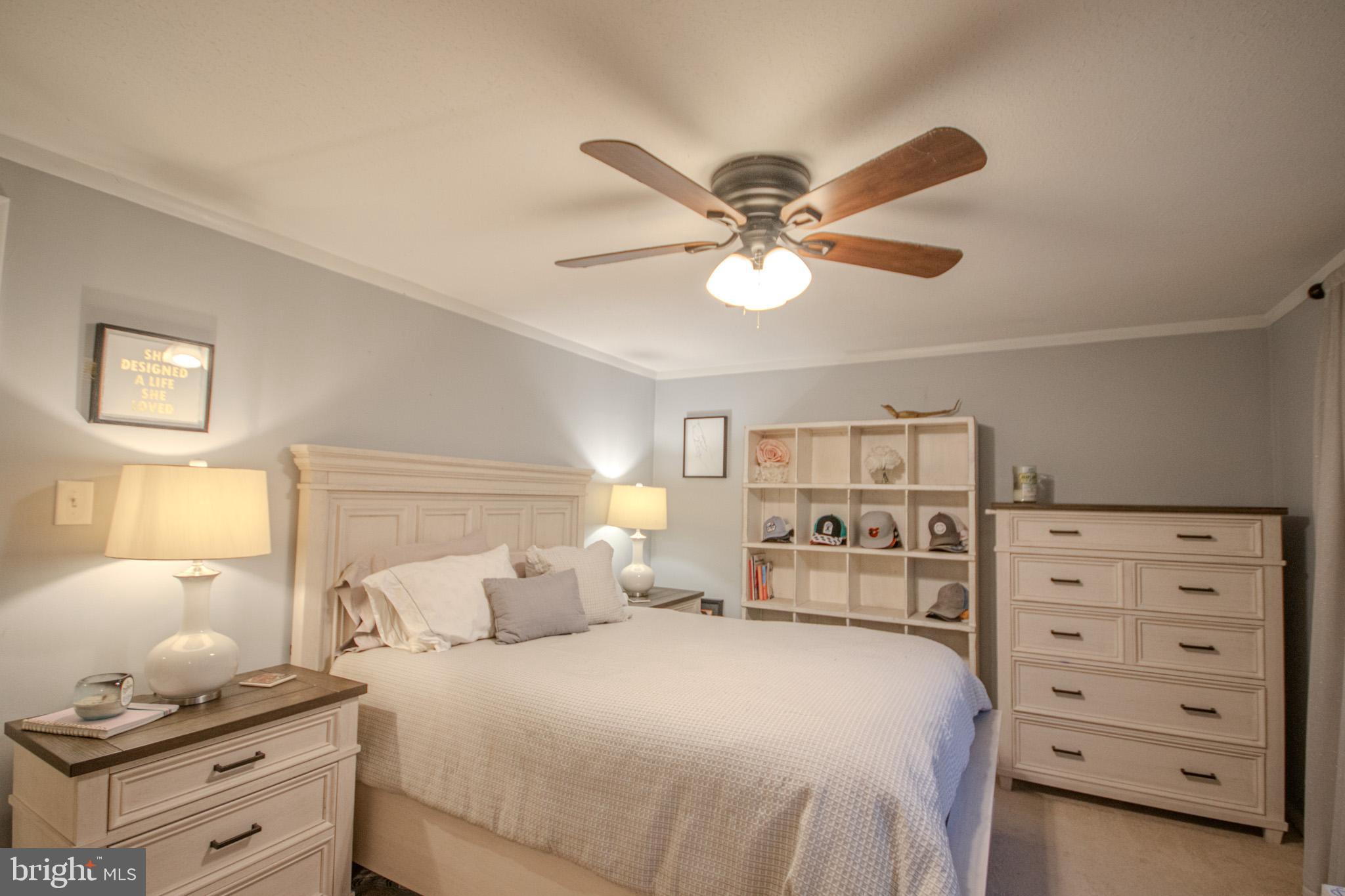 60 Beaconhill Road Ocean Pines, MD 21811 - Photo 17 of 30 a bedroom with a bed and a chandelier