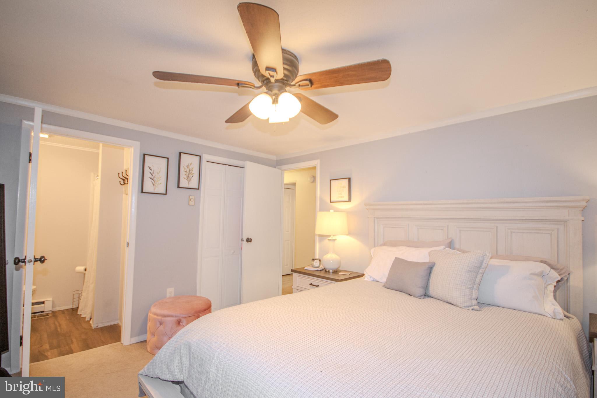 60 Beaconhill Road Ocean Pines, MD 21811 - Photo 18 of 30 a bedroom with a bed and a chandelier