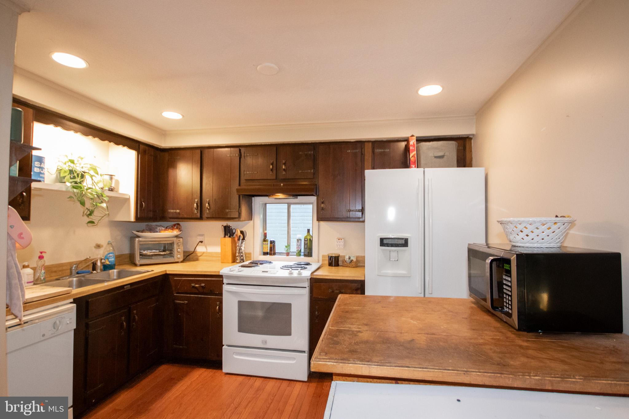 60 Beaconhill Road Ocean Pines, MD 21811 - Photo 10 of 30 a kitchen with a sink a stove and refrigerator