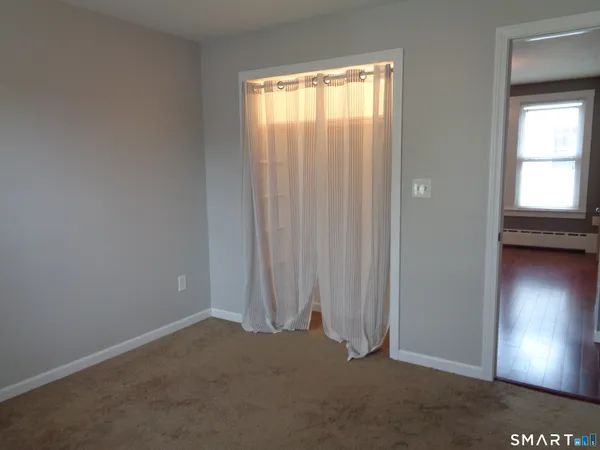 an empty room with windows and closet