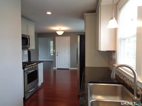 a kitchen with a sink cabinets and stainless steel appliances