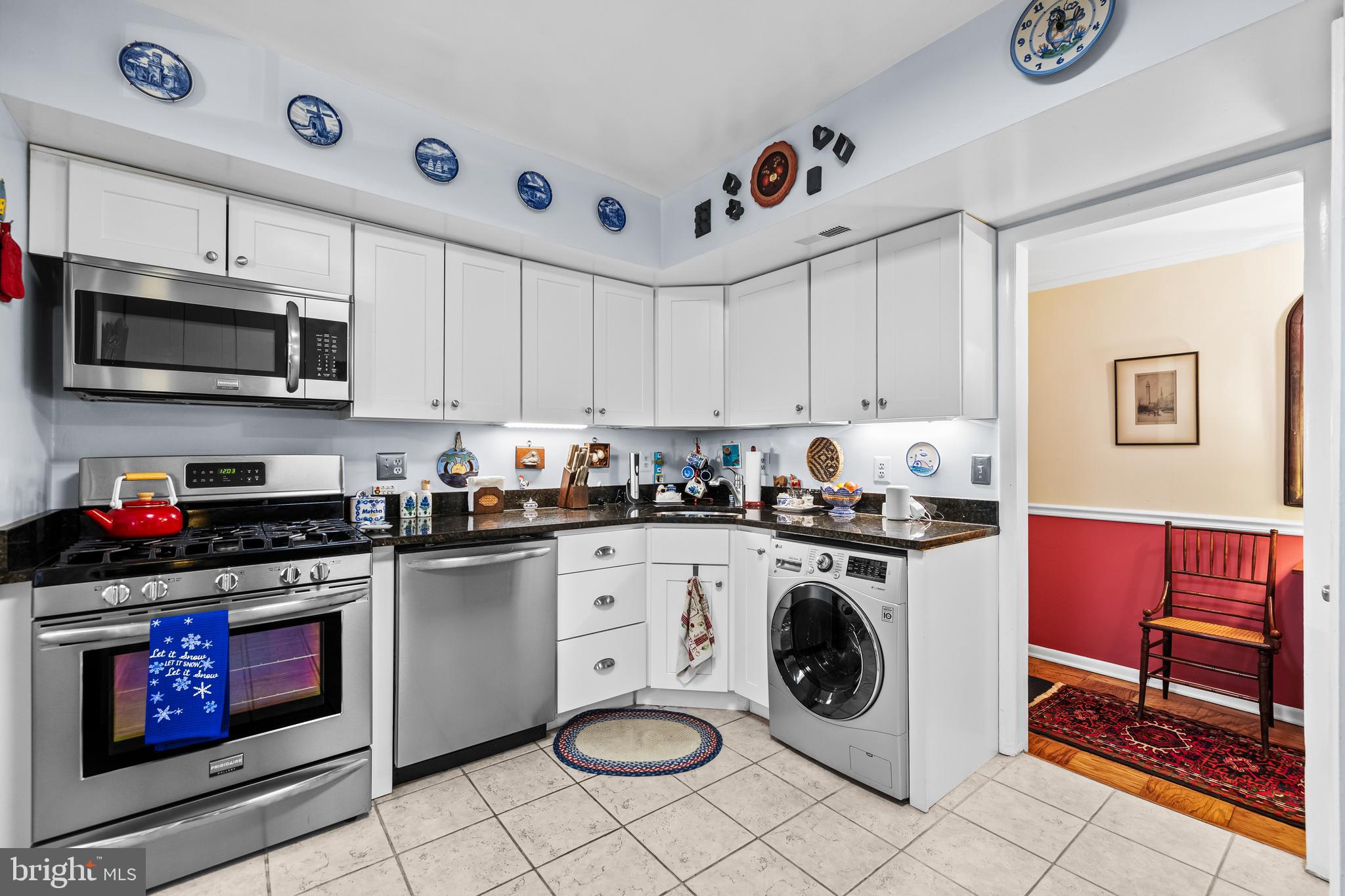 107 Cross Keys Road, Unit R107C Baltimore, MD 21210 - Photo 11 of 40 a kitchen with stainless steel appliances granite countertop a stove and a microwave