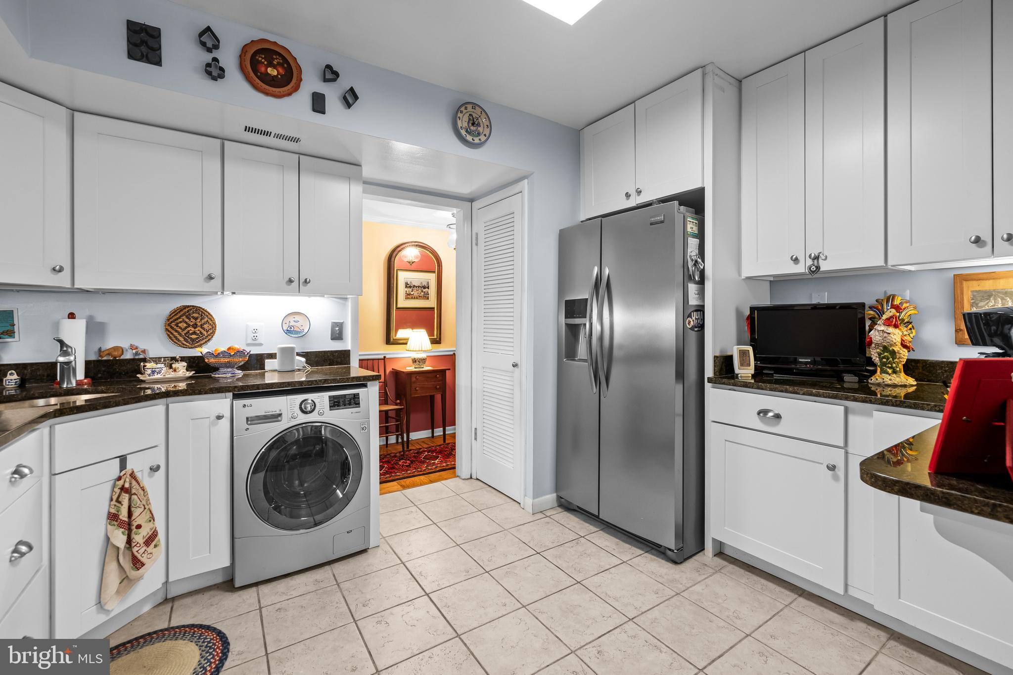 107 Cross Keys Road, Unit R107C Baltimore, MD 21210 - Photo 12 of 40 a kitchen with a stove a refrigerator and cabinets
