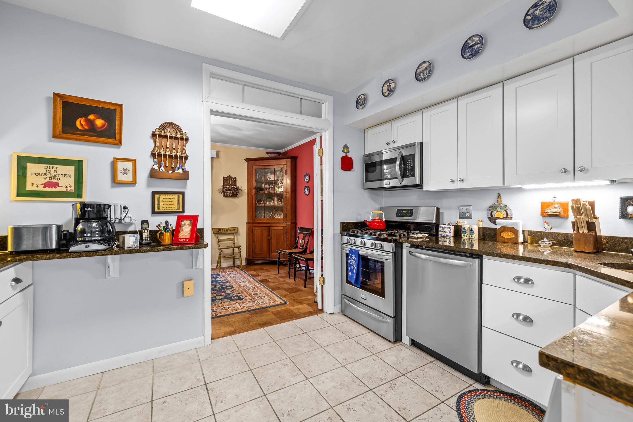 107 Cross Keys Road, Unit R107C Baltimore, MD 21210 - Photo 13 of 40 a kitchen with stainless steel appliances granite countertop a refrigerator and sink