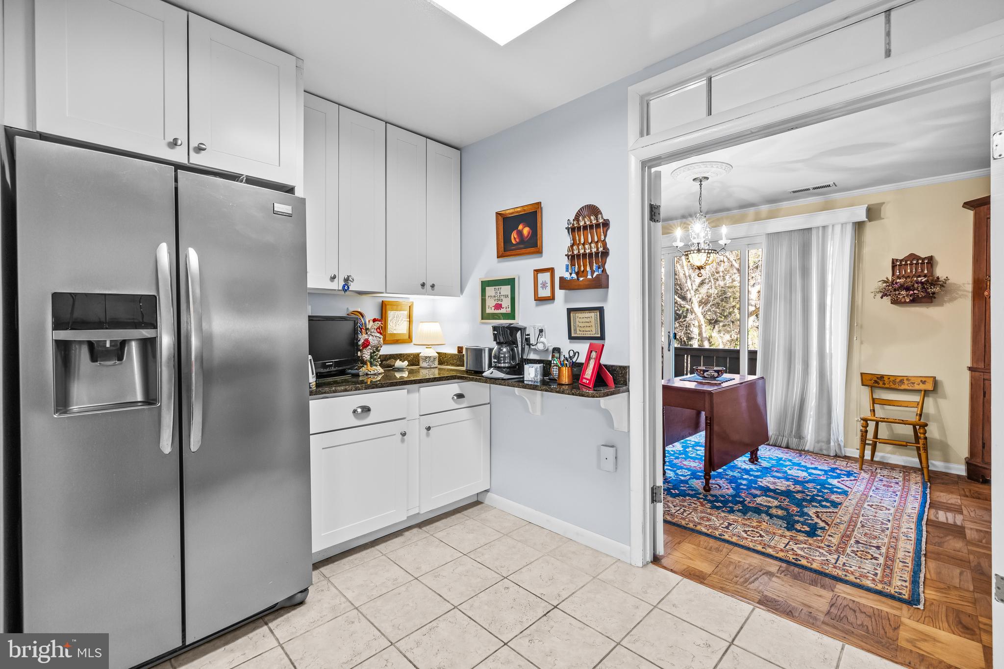 107 Cross Keys Road, Unit R107C Baltimore, MD 21210 - Photo 14 of 40 a kitchen with stainless steel appliances granite countertop a refrigerator and a sink