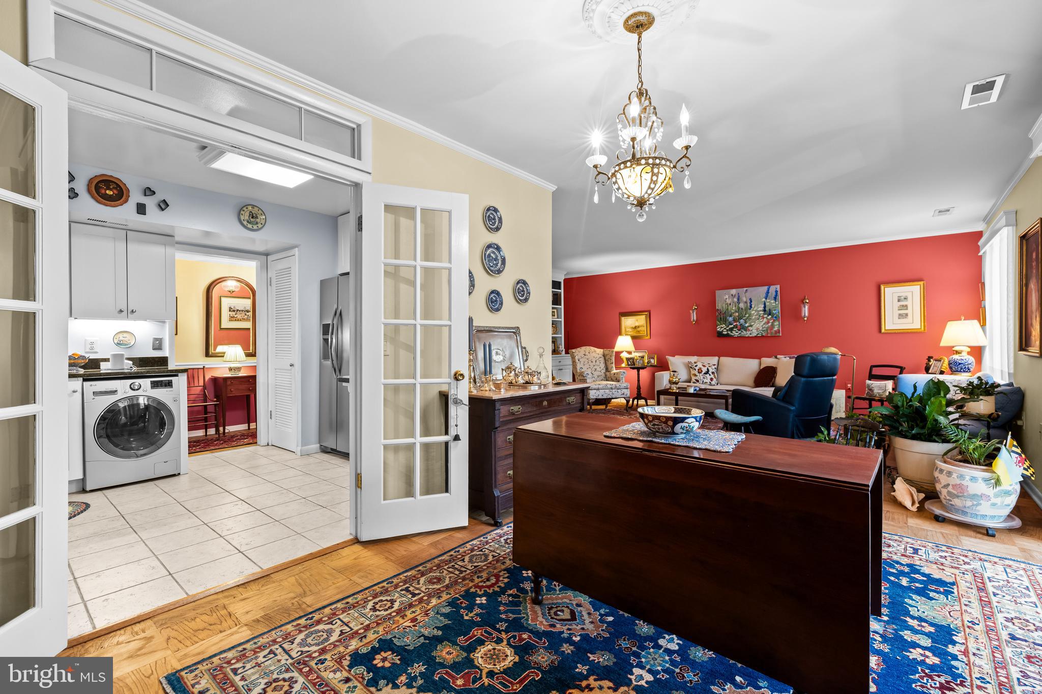 107 Cross Keys Road, Unit R107C Baltimore, MD 21210 - Photo 15 of 40 a view of a dining room with furniture a chandelier and wooden floor
