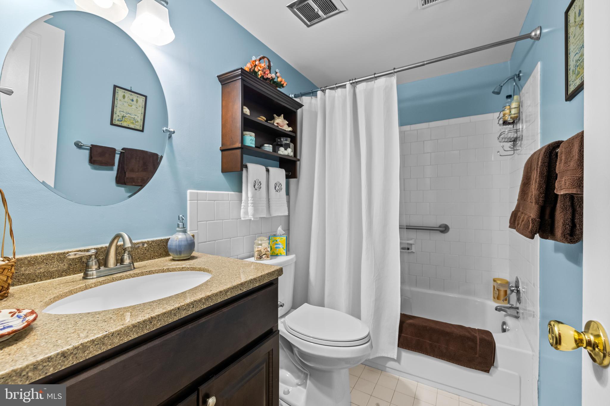 107 Cross Keys Road, Unit R107C Baltimore, MD 21210 - Photo 23 of 40 a bathroom with a granite countertop sink and a mirror