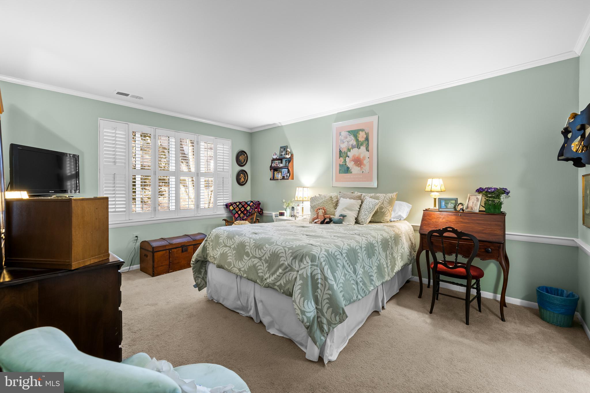 107 Cross Keys Road, Unit R107C Baltimore, MD 21210 - Photo 26 of 40 a bedroom with a bed and a flat screen tv