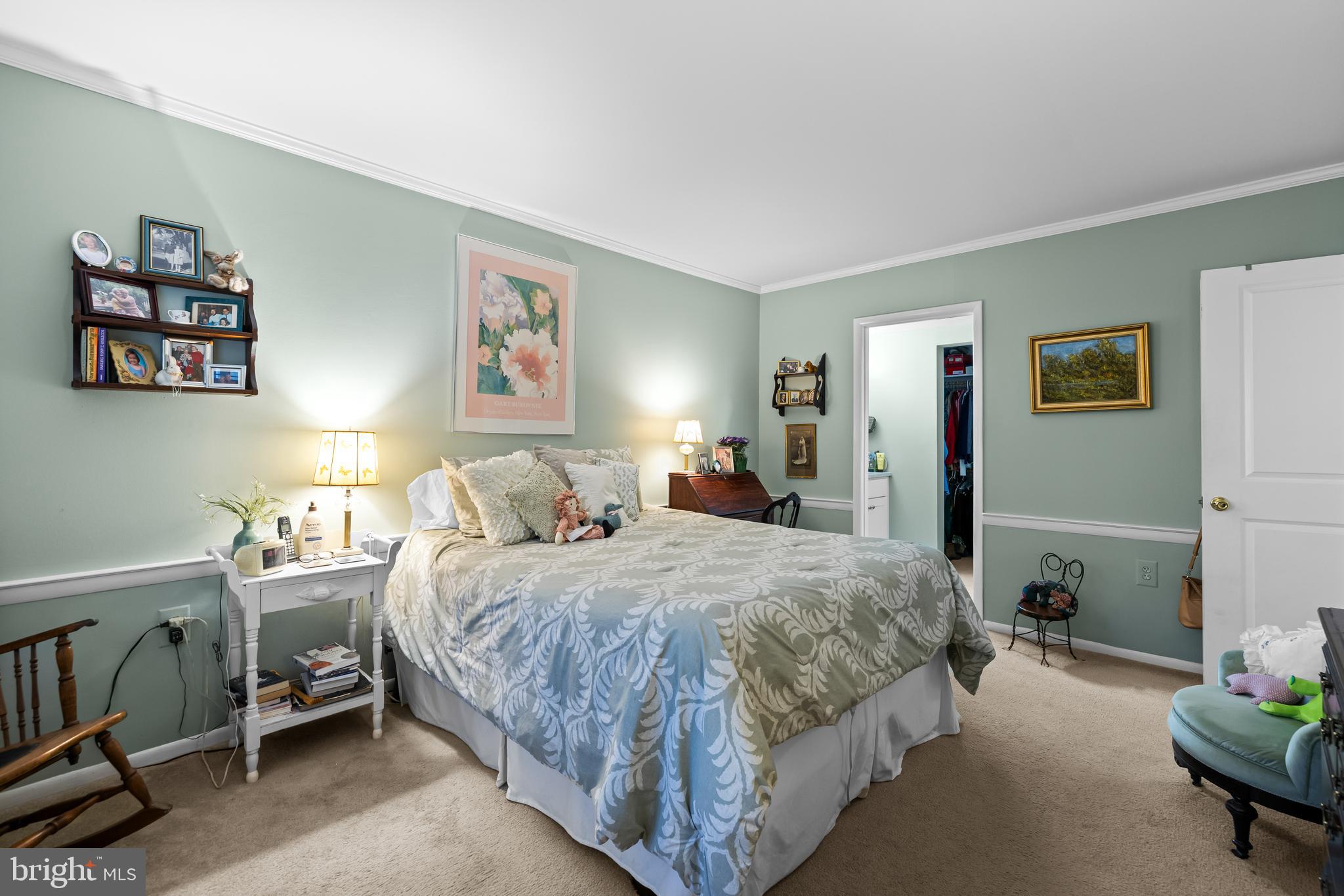 107 Cross Keys Road, Unit R107C Baltimore, MD 21210 - Photo 28 of 40 a bedroom with a bed and a lamp on table