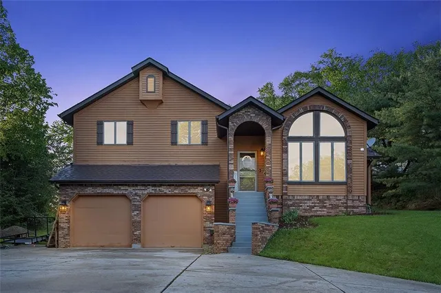 a front view of a house with a yard and garage