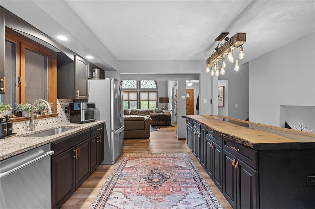 6178 Baker School Road Trafford, PA 15085 - Photo 15 of 48 a large kitchen with a center island and large windows