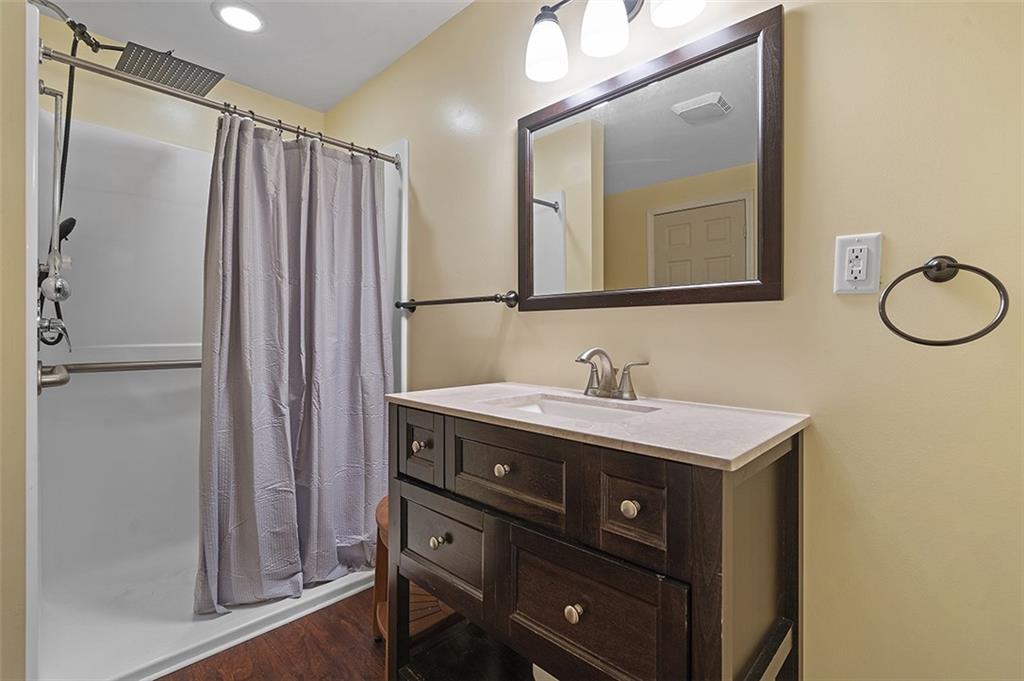 6178 Baker School Road Trafford, PA 15085 - Photo 27 of 48 a bathroom with a sink a mirror and a shower
