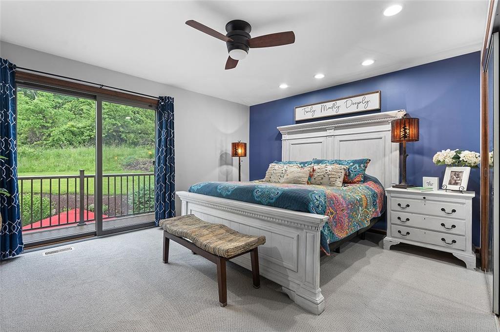 6178 Baker School Road Trafford, PA 15085 - Photo 28 of 48 a bedroom with a bed and a chandelier