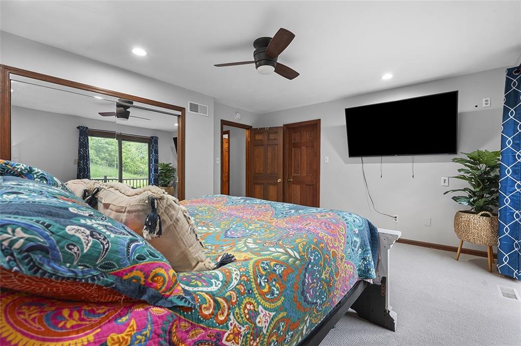 6178 Baker School Road Trafford, PA 15085 - Photo 29 of 48 a bedroom with a bed a window and a flat screen television