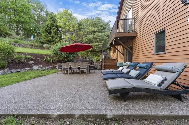 a view of a patio with a table and chairs under an umbrella