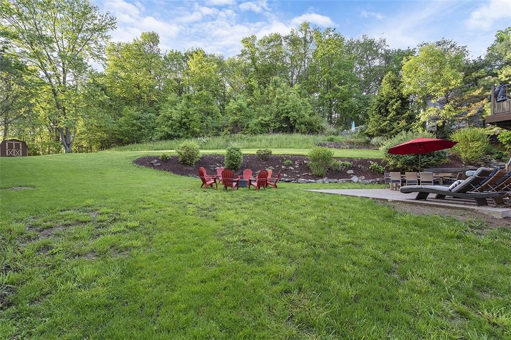 6178 Baker School Road Trafford, PA 15085 - Photo 44 of 48 a view of a lake with a yard and a bench