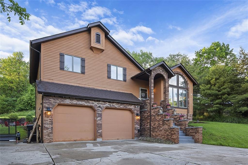 6178 Baker School Road Trafford, PA 15085 - Photo 48 of 48 a front view of a house with a yard and garage