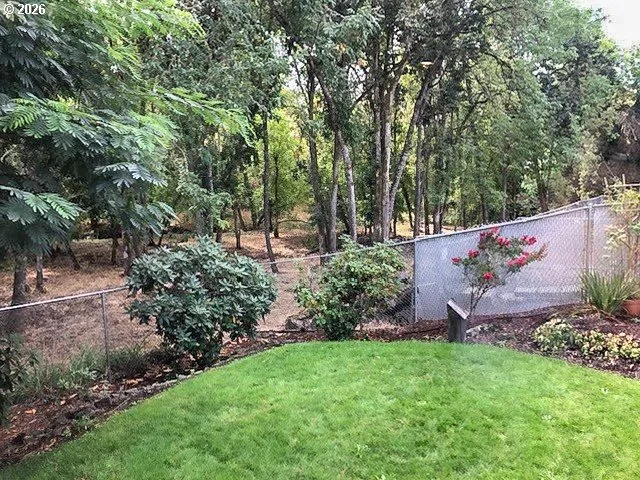 a view of a chairs and table in front of house