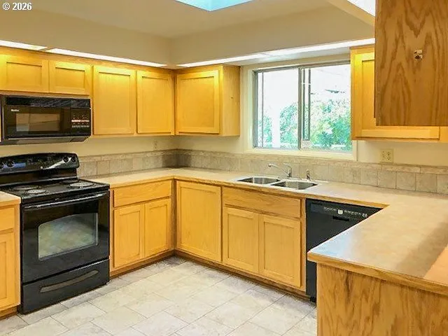 a kitchen with a sink stove and microwave