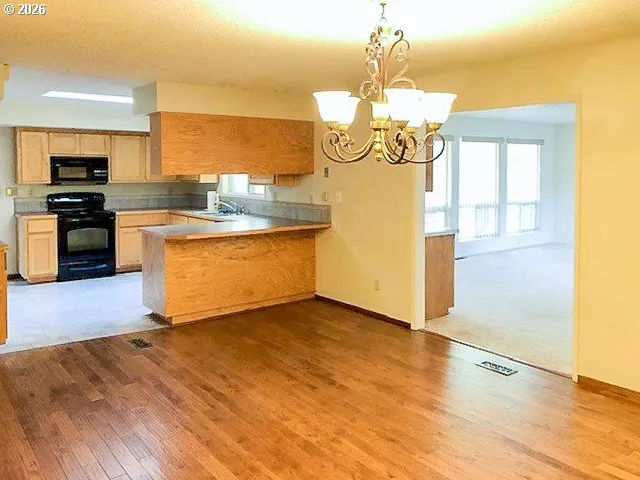 a kitchen with stainless steel appliances granite countertop a sink and a stove