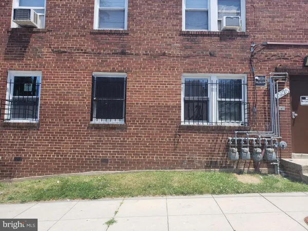 a brick house with a door and a yard