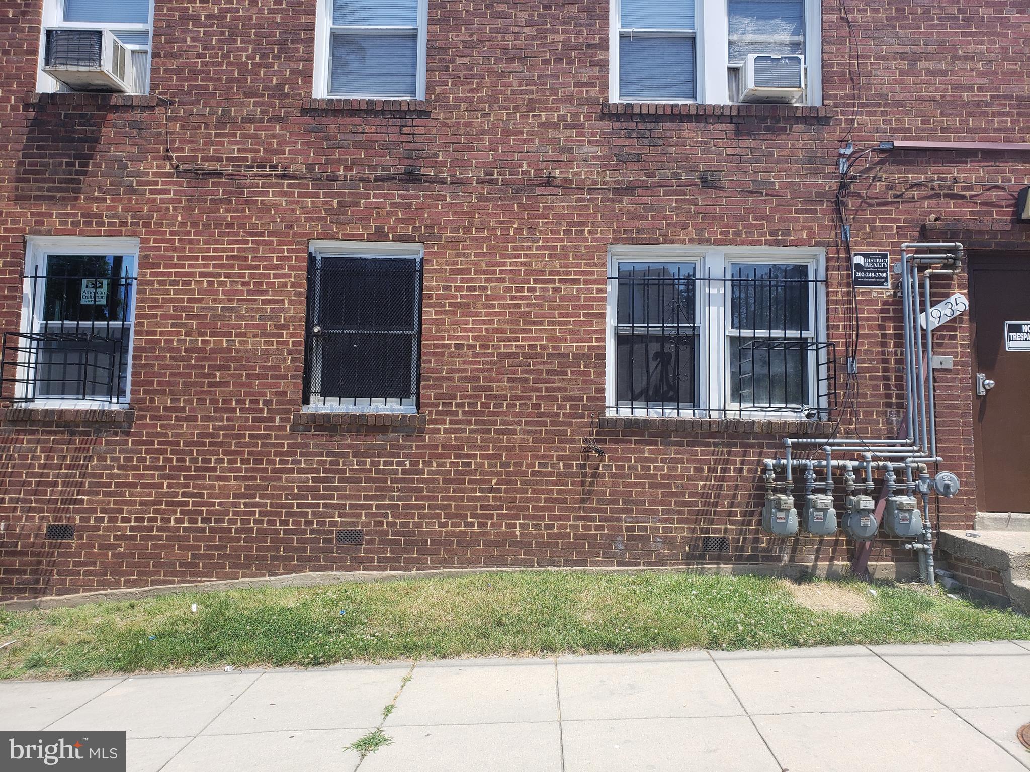935 48th Place Northeast Washington, DC 20019 - Photo 1 of 5 a brick house with a door and a yard