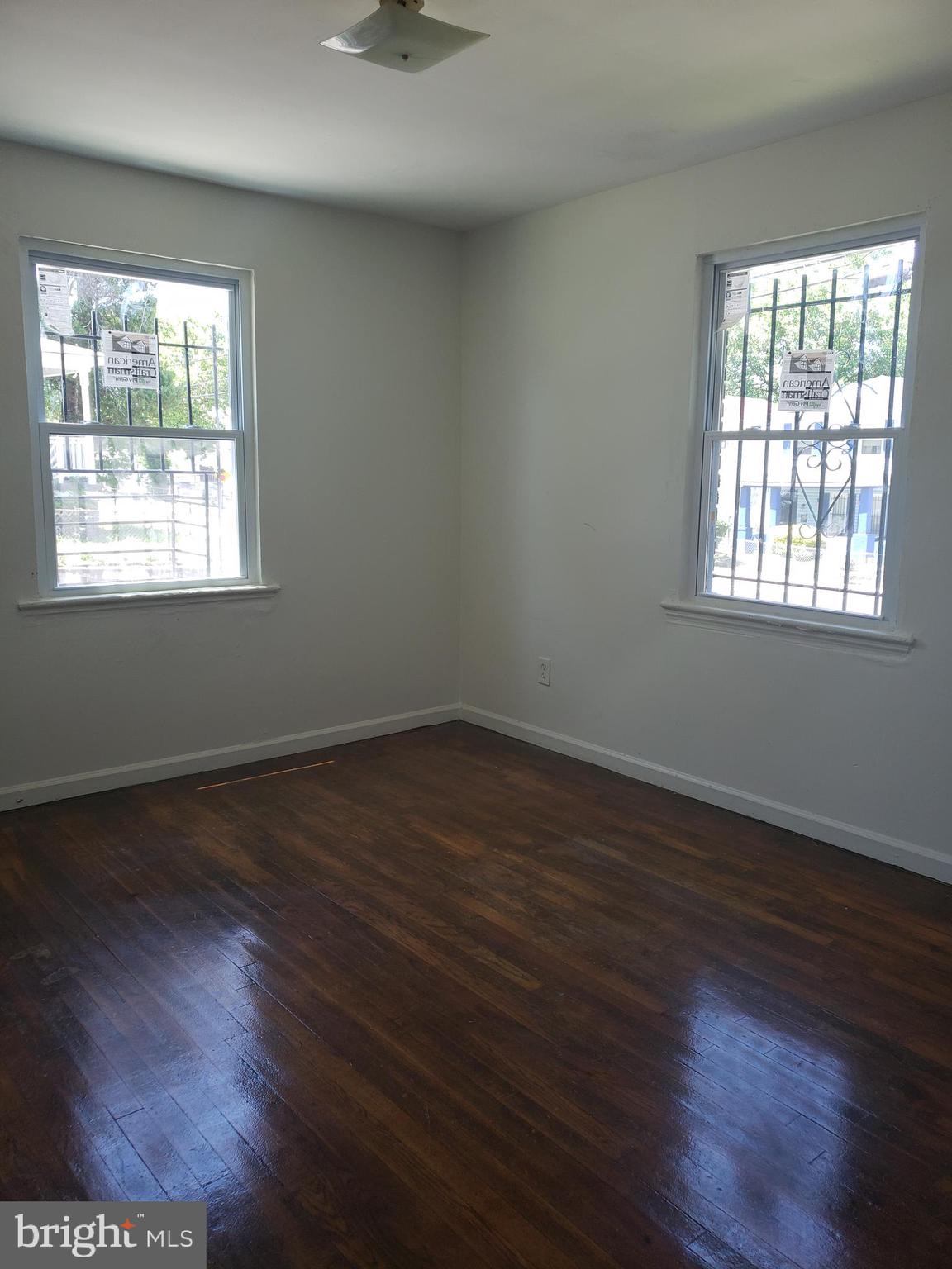 935 48th Place Northeast Washington, DC 20019 - Photo 5 of 5 an empty room with wooden floor and windows