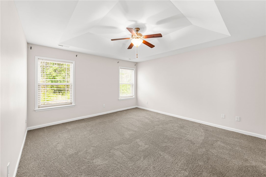 113 Crofton Court Easley, SC 29642 - Photo 22 of 33 This spacious room features a beautiful tray ceiling, soft carpeting, and abundant natural light.