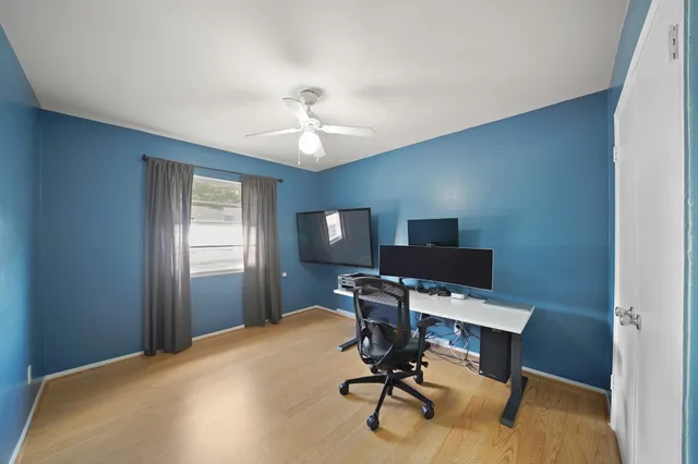 a view of a workspace with furniture and a window