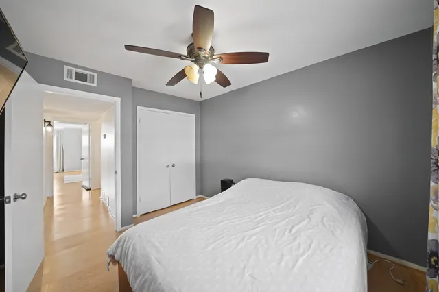 a bedroom with a large bed and a chandelier