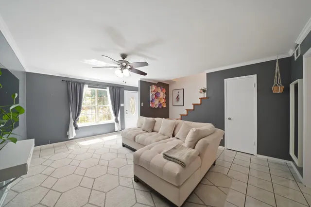a living room with furniture and a chandelier