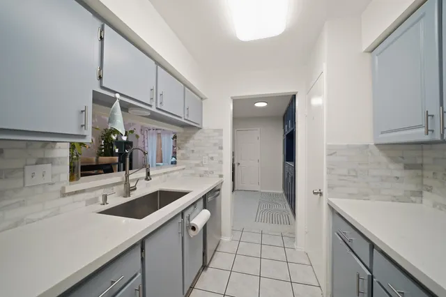 a kitchen with a sink cabinets and entryway