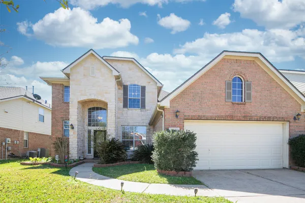 a view of a white house next to a yard