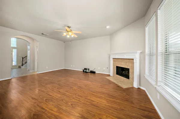 a view of an empty room with a fireplace and a window