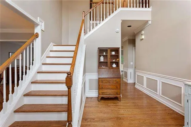 a view of entryway and hall with wooden floor