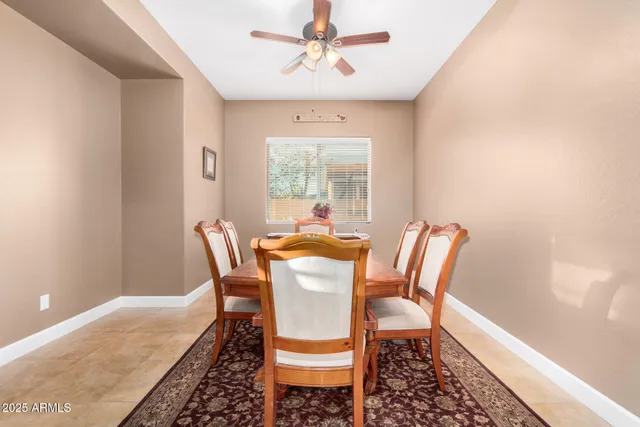 a dining room with furniture a chandelier and wooden floor