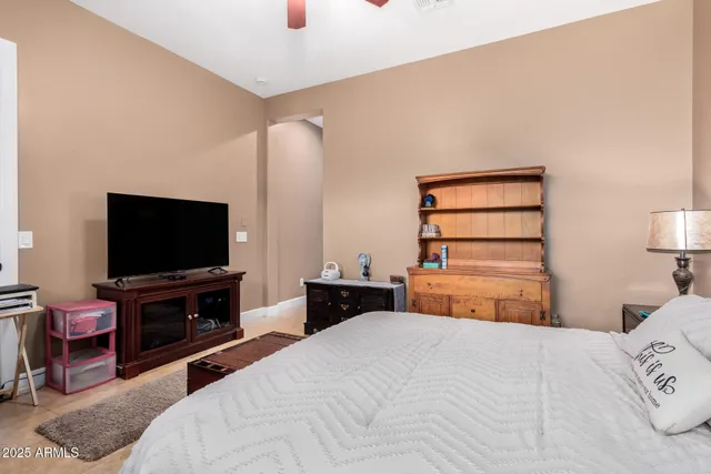 a bedroom with a bed and a flat screen tv